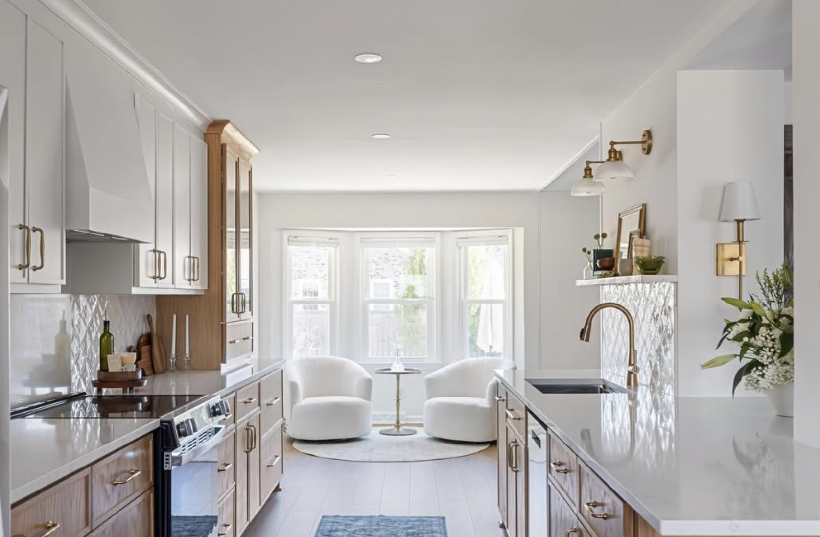 Bright kitchen with wood cabinetry, white countertops, and brass accents beneath “As Seen In Architectural Digest”